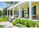 Inviting front porch with comfortable seating and lush landscaping at 1212 S Riverside Dr, New Smyrna Beach, FL 32168