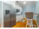 Eat-in kitchen featuring white cabinets, stainless steel appliances and hardwood floors at 1212 S Riverside Dr, New Smyrna Beach, FL 32168