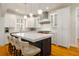 Bright kitchen boasts a large island with countertop seating, pendant lighting, and modern stainless steel appliances at 1212 S Riverside Dr, New Smyrna Beach, FL 32168