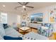 Cozy living room with a plush sectional, ceiling fan, and coastal decor at 1212 S Riverside Dr, New Smyrna Beach, FL 32168