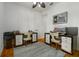 Bright office with a ceiling fan, two desks, and hardwood flooring at 1212 S Riverside Dr, New Smyrna Beach, FL 32168