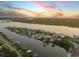 Breathtaking aerial view of a waterfront community, showcasing stunning sunsets and various homes with boat docks at 1219 Commodore Dr, New Smyrna Beach, FL 32168