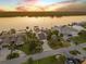 Aerial view of elegant waterfront houses with lush landscaping, private docks, and beautiful sunset views at 1219 Commodore Dr, New Smyrna Beach, FL 32168