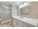 Bathroom with a white vanity, modern faucet, and a glass-enclosed tiled shower with a small garden window at 1219 Commodore Dr, New Smyrna Beach, FL 32168