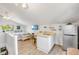 Cozy bedroom featuring a kitchenette, tv, a comfortable bed and a large window for natural light at 1219 Commodore Dr, New Smyrna Beach, FL 32168