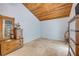 Bedroom with vaulted wood ceilings and travertine floors, decorated with antique furniture at 1219 Commodore Dr, New Smyrna Beach, FL 32168