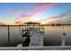 Private boat dock with a covered area is perfect for boating, fishing, and water sports at 1219 Commodore Dr, New Smyrna Beach, FL 32168