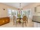 Elegant dining room featuring a glass table, a chandelier, and shuttered windows at 1219 Commodore Dr, New Smyrna Beach, FL 32168