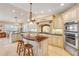 Spacious kitchen featuring custom cabinets, a wood island, and stainless steel appliances at 1219 Commodore Dr, New Smyrna Beach, FL 32168