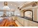 Gourmet kitchen with custom cabinetry, a wood island, and a breakfast nook with water views at 1219 Commodore Dr, New Smyrna Beach, FL 32168