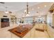 Bright and airy kitchen with a wood island, built-in shelving, and open floor plan at 1219 Commodore Dr, New Smyrna Beach, FL 32168