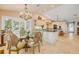 Open concept kitchen featuring granite countertops, stainless steel appliances, and a breakfast nook with bay windows at 1219 Commodore Dr, New Smyrna Beach, FL 32168