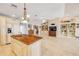 Open kitchen featuring custom cabinets, a wood island, and views of the living area at 1219 Commodore Dr, New Smyrna Beach, FL 32168