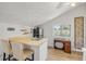 Cozy kitchenette featuring a sink, refrigerator, a desk and a large window with natural light at 1219 Commodore Dr, New Smyrna Beach, FL 32168