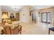 Open living room features travertine floors, neutral tones and decorative furnishings at 1219 Commodore Dr, New Smyrna Beach, FL 32168