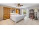 Spacious main bedroom with travertine floors, built-ins, ensuite bathroom, and private outdoor access at 1219 Commodore Dr, New Smyrna Beach, FL 32168