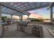 Gourmet outdoor kitchen features stainless steel appliances and counter space for entertaining at 1219 Commodore Dr, New Smyrna Beach, FL 32168