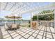 An outdoor kitchen space with an umbrella-covered dining table at 1219 Commodore Dr, New Smyrna Beach, FL 32168