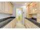 Walk-through pantry featuring custom cabinets and granite countertops at 1219 Commodore Dr, New Smyrna Beach, FL 32168