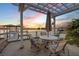 Outdoor patio features a dining set and seating under a pergola with water views at 1219 Commodore Dr, New Smyrna Beach, FL 32168