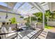 A stylish patio area with comfortable seating, shaded by a pergola at 1219 Commodore Dr, New Smyrna Beach, FL 32168