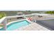 A stunning rooftop pool with views of the bay and stylish red lounge chairs at 1219 Commodore Dr, New Smyrna Beach, FL 32168