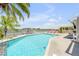 A stunning pool with views of the bay, a gazebo and stylish red lounge chairs at 1219 Commodore Dr, New Smyrna Beach, FL 32168