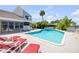 A swimming pool with an outdoor lounging area and lush landscaping at 1219 Commodore Dr, New Smyrna Beach, FL 32168