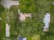 Aerial view of a house surrounded by lush trees, with rooftops and glimpses of the surrounding neighborhood at 1331 Needle Palm Dr, Edgewater, FL 32132