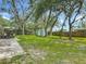 Spacious backyard with mature trees, a storage shed, and a hammock at 1331 Needle Palm Dr, Edgewater, FL 32132