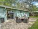Inviting backyard patio with outdoor seating and lush landscaping at 1331 Needle Palm Dr, Edgewater, FL 32132