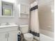 Clean bathroom featuring a toilet, sink with a mirror, vanity, and a tub with a shower curtain at 1331 Needle Palm Dr, Edgewater, FL 32132