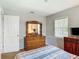 Bedroom view with soft lighting, cozy bed, dresser, and window, providing a serene and inviting atmosphere at 1331 Needle Palm Dr, Edgewater, FL 32132
