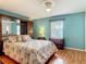 Bedroom showcasing mirrored closet doors, offering a comfortable space with colorful accents and soft textures at 1331 Needle Palm Dr, Edgewater, FL 32132