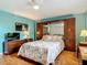 Comfortable bedroom featuring a stylish seashell-themed comforter and dark wood furniture at 1331 Needle Palm Dr, Edgewater, FL 32132