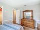 Bedroom showing a dresser with mirror offering a bright, comfortable space with neutral walls and soft textures at 1331 Needle Palm Dr, Edgewater, FL 32132