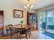 Cozy dining room featuring a wooden table with seating for four, a chandelier, and sliding glass doors at 1331 Needle Palm Dr, Edgewater, FL 32132