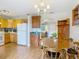 Eat-in kitchen featuring a dining table, wood cabinets, and an arched doorway to another living space at 1331 Needle Palm Dr, Edgewater, FL 32132