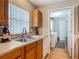 A kitchen sink with wood cabinets and a window at 1331 Needle Palm Dr, Edgewater, FL 32132