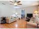 Inviting living room features wood floors, a ceiling fan, and comfortable seating at 1331 Needle Palm Dr, Edgewater, FL 32132