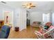 Bright living room featuring a ceiling fan, natural light, and multiple doorways at 1331 Needle Palm Dr, Edgewater, FL 32132