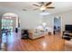 Bright living room with hardwood floors, ceiling fan, and neutral-toned walls at 1331 Needle Palm Dr, Edgewater, FL 32132
