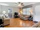 Bright living room with hardwood floors, a ceiling fan, and neutral-toned walls and white trim at 1331 Needle Palm Dr, Edgewater, FL 32132