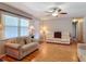 Cozy living room features hardwood floors, ceiling fan, and comfortable seating at 1331 Needle Palm Dr, Edgewater, FL 32132