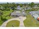 Home showcasing its fenced yard, driveway, and proximity to neighboring houses at 2416 Pine Tree Dr, Edgewater, FL 32141