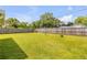 Expansive backyard featuring lush green grass, a new fence, and a very private setting at 2416 Pine Tree Dr, Edgewater, FL 32141