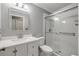 Bright bathroom featuring a shower with sliding glass doors and a vanity with marble countertop at 2416 Pine Tree Dr, Edgewater, FL 32141