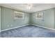 Comfortable bedroom with blue walls, carpet, and a ceiling fan at 2416 Pine Tree Dr, Edgewater, FL 32141