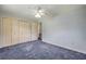 Bedroom featuring carpeted floors, a ceiling fan, and closet at 2416 Pine Tree Dr, Edgewater, FL 32141