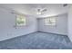 Bedroom with soft blue walls, carpet, and a ceiling fan at 2416 Pine Tree Dr, Edgewater, FL 32141